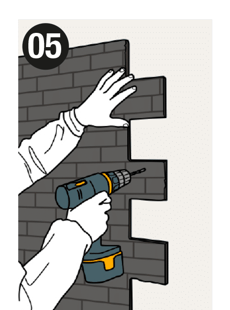 Step 5 of the installation: Hold the panel against the wall and drill with a 3 mm bit, preferably along the joints, going through the panel to mark the wall where the plug will go later.